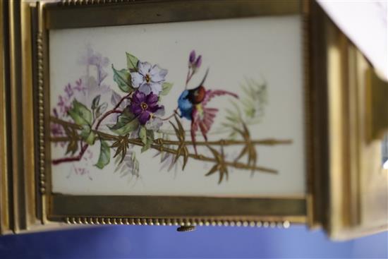 An early 20th century ormolu and porcelain hour repeating carriage clock, 6.5in., with travelling case